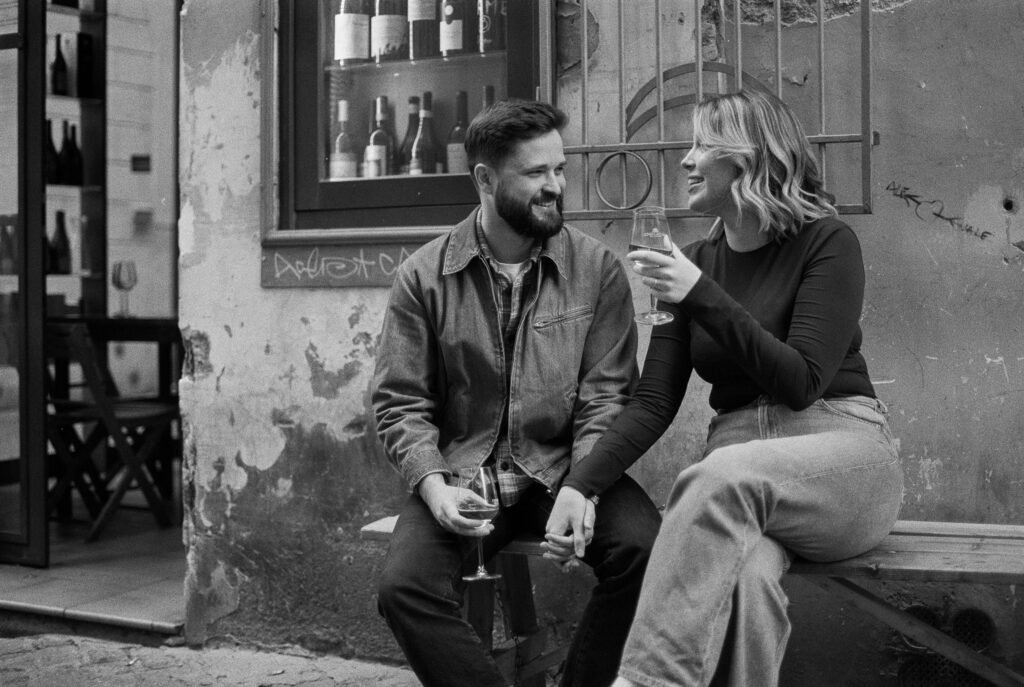Young couple having white wine in Rome.
