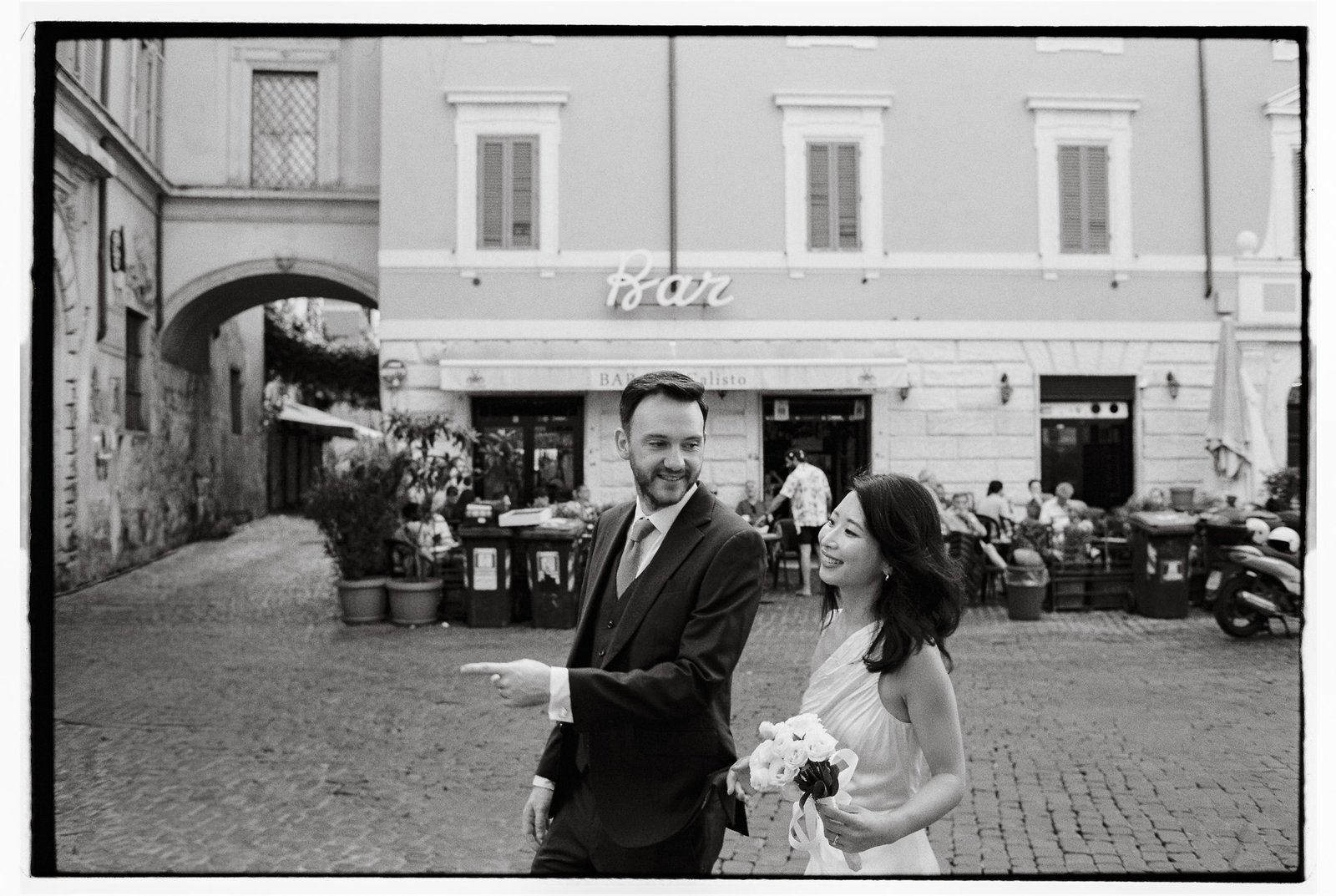 Bride and groom walking in Trastevere during their pre wedding photoshoot in Rome.