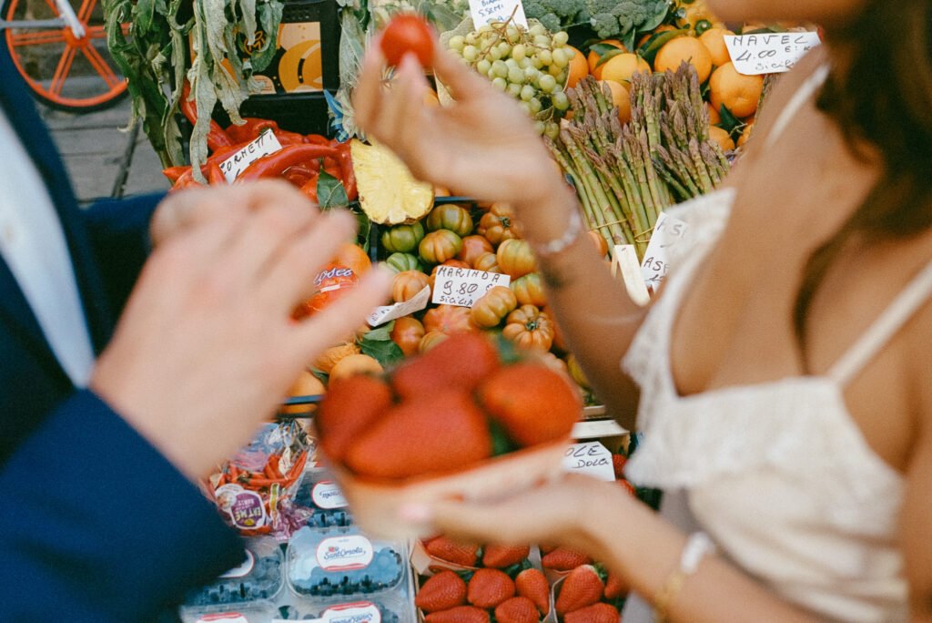 close up of couple hands holding strawberries at Florence market photoshoot