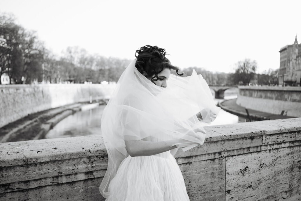 bride portrait veil flowing river rome candid black and white destination wedding photographer italy