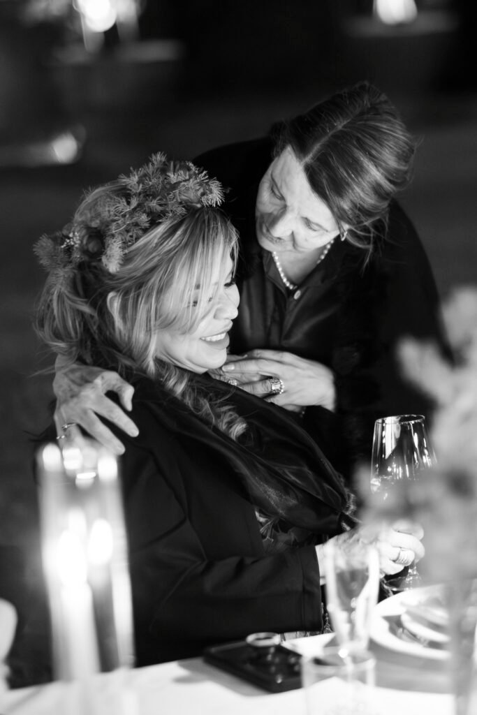 emotional wedding moment groom's mother comforting bride's mother candid documentary wedding photography italy black and white