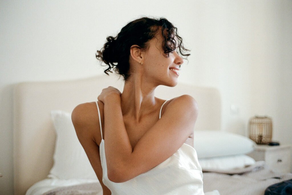 Bride getting ready in a white dress during a destination wedding in Italy photographed on 35mm analogue film