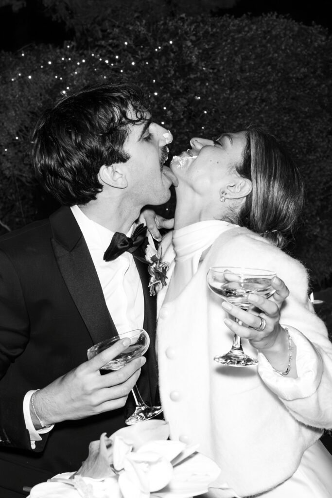 Bride and groom laughing with cake on their faces during a candid wedding reception in Ronciglione.