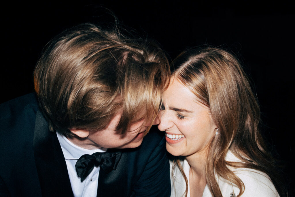 Madeline and Josh touch foreheads and smile together during their evening alternative wedding reception in Rome.
