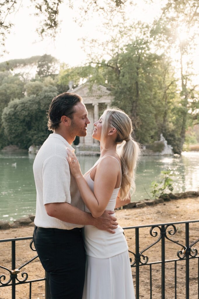 Riley and Maddie sharing a quiet moment beside the lake during their Villa Borghese couple photoshoot